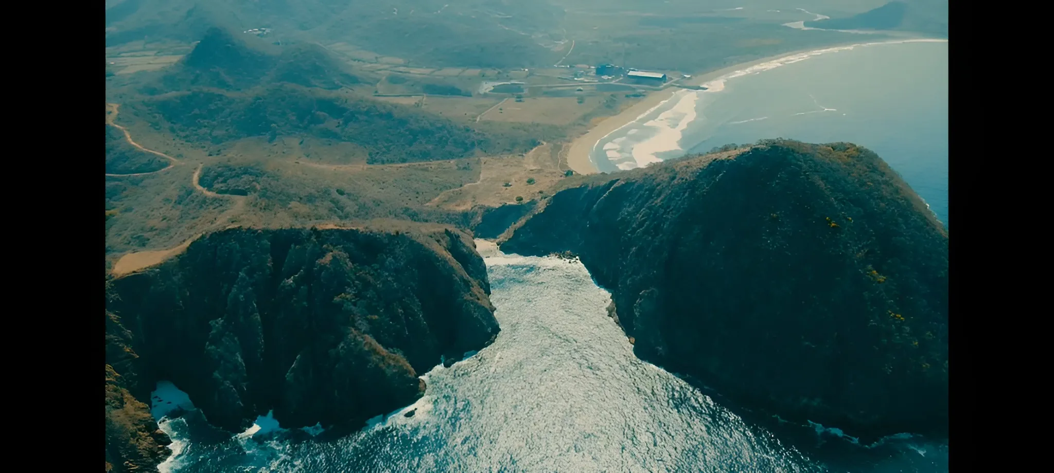 Aerial view of coastal hills and headlands beside turquoise water — Kertasari, West Sumbawa