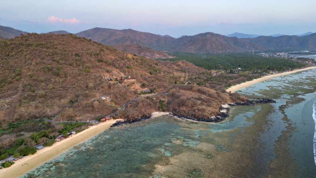 Aerial view of the Glampar Beach coastline and surrounding hills in Kertasari, West Sumbawa.