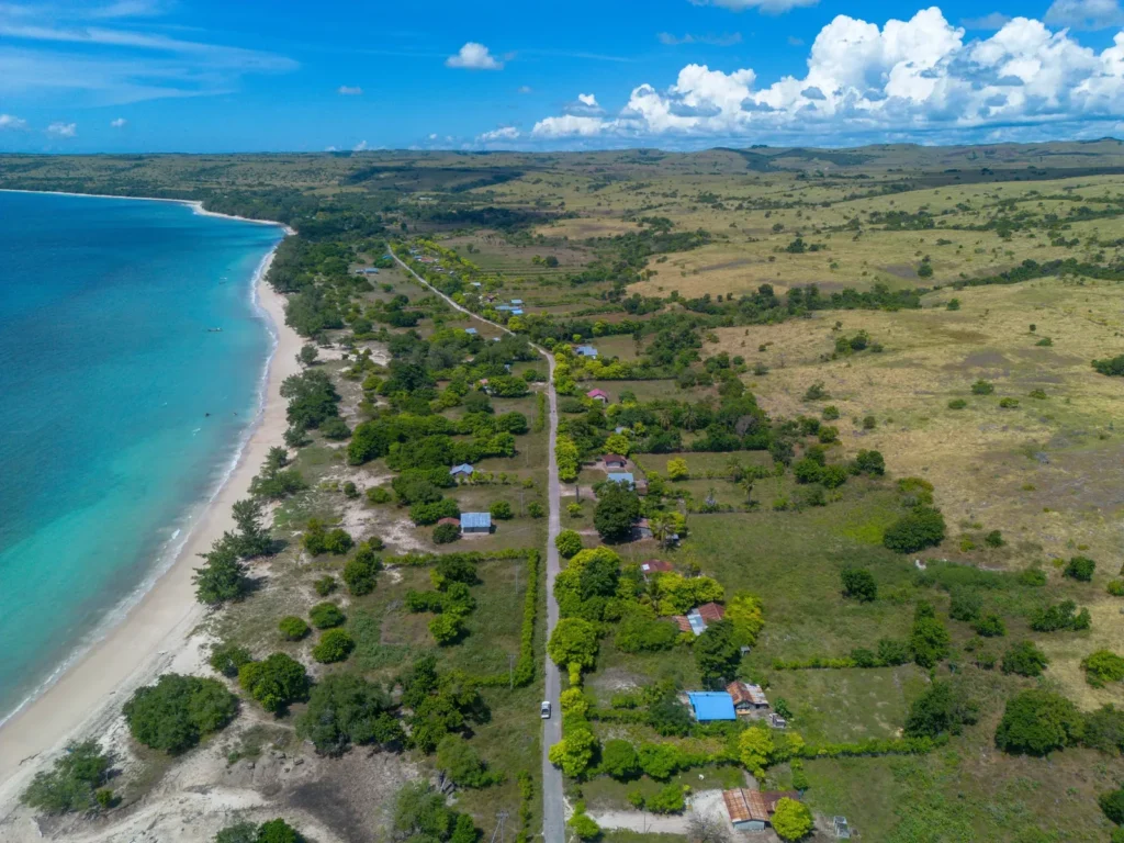 Aerial panorama of the long beach and surrounding fields at Lenang Beachfront, Lenang, Umbu Ratu Nggay, Central Sumba