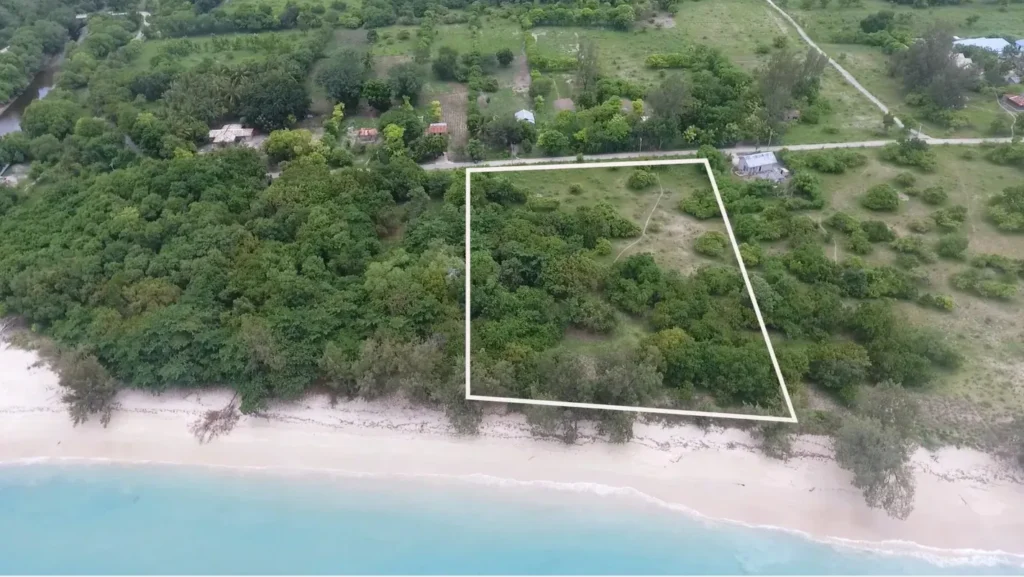 Beachfront plot outline beside trees and turquoise water at Lenang Beachfront, Lenang, Central Sumba